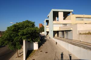 a person standing on a sidewalk next to a building at HI Abrantes – Pousada de Juventude in Abrantes