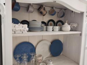 a shelf filled with plates and cups and dishes at Auszeit in Freital