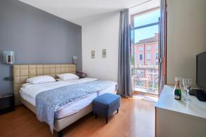 a bedroom with a bed and a large window at Hotel Zurigo Downtown in Lugano