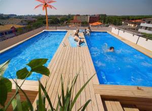 a group of people in a swimming pool on a building at Hotel Di Giovanni in Bibione