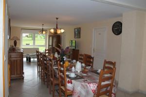 a dining room with a table and chairs at Chambres d'hôtes La Trottelée in Bellefontaine