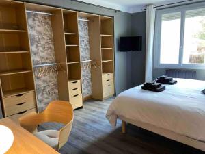 a bedroom with a bed and shelves and a window at Maison climatisée avec stationnement et wifi in Bram