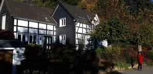 a person standing in front of a house at Ferienwohnung Koch in Odenthal