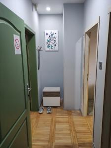 a hallway with a door and a room with a table at Srafko apartment in Subotica