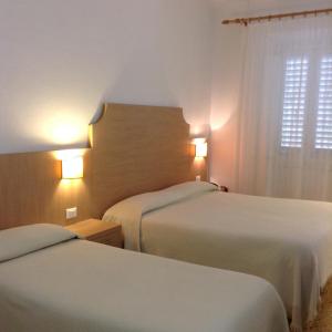 A bed or beds in a room at Albergo Giugni