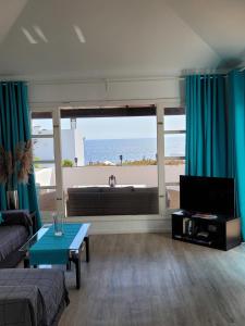 a living room with a view of the ocean at Lago Verde Suite 25 in Puerto del Carmen