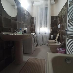 een badkamer met een wastafel, een toilet en een spiegel bij Casa VINCENZO 130 mq con 2 Bagni ed ingresso esclusivo dal giardino in Felino