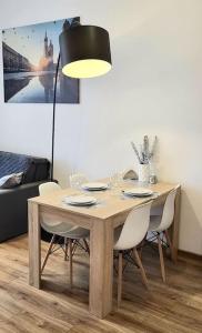 a dining room table with chairs and a lamp at Modern Silver Apartment 2 rooms Bosacka Old Town in Krakow