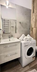 a bathroom with a washing machine and a sink at Modern Silver Apartment 2 rooms Bosacka Old Town in Krakow