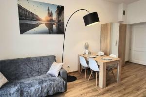 a living room with a table and a couch at Modern Silver Apartment 2 rooms Bosacka Old Town in Krakow
