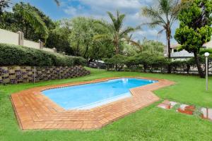 a swimming pool in the yard of a house at Modern 2 bedroom apartment in vibrant Melville 99 in Johannesburg