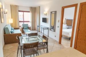 a living room with a table and chairs in a room at Hotel Oh Nice Caledonia in Estepona