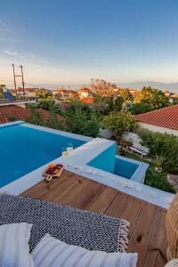 a view of a swimming pool from the roof of a house at Georgianna's suite with private pool , 'blank suite' in Kharokopión