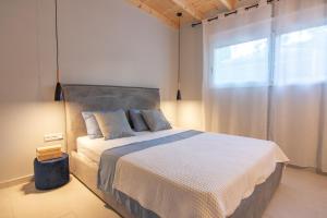 a bedroom with a large bed and a window at Georgianna's suite with private pool , 'blank suite' in Kharokopión