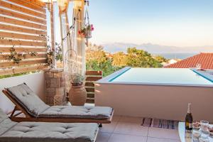 a patio with a swimming pool and a hot tub at Georgianna's suite with private pool , 'blank suite' in Kharokopión