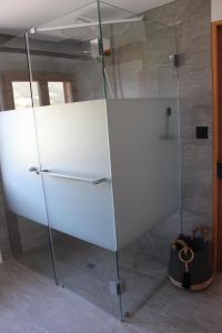 a shower with a glass door in a bathroom at paclera79 in Santa Maria Val Müstair