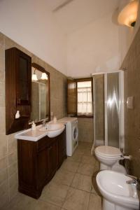 a bathroom with a sink and a toilet and a shower at Relais Il Ciliegio in Sorano
