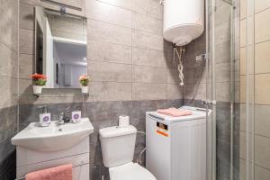 a small bathroom with a toilet and a sink at Magic Badalona Apartment in Badalona