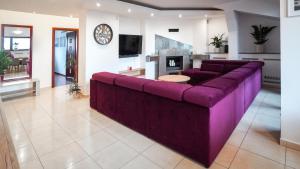 a large purple couch in a living room at Apartament Wschodnia in Lublin