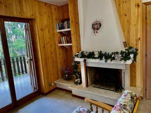 a living room with a fireplace with christmas decorations at NadSan Mountain House in Camigliatello Silano