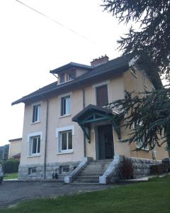 a large house with stairs in front of it at Refuges sous les toits in Bourg-Saint-Maurice