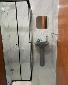 a bathroom with a glass shower and a sink at POSADA DON CANDIDO in San Antonio