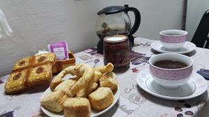 a table with a plate of pastries and a cup of coffee at Monoambiente Blanca in Concordia