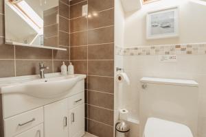 een badkamer met een wastafel en een toilet bij Bennar Isa Cottages Dyffryn Ardudwy in Barmouth