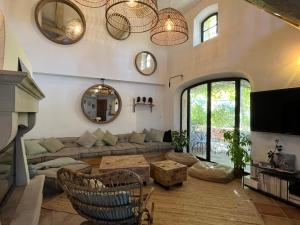 a living room with a couch and a table at Hestia in Robion en Luberon