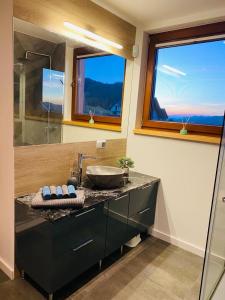 a bathroom with a sink and a glass shower at Scenic Chalet Malowniczy Domek in Szlembark
