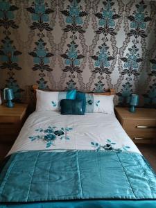 a bedroom with a bed with a blue comforter at Hillview House in Bellaghy
