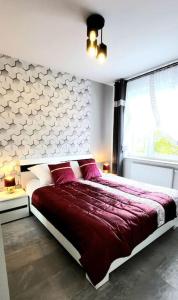 a bedroom with a red bed and a window at Cozy RED ROSE Apartment, 2 rooms Down Town in Kraków