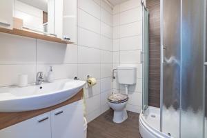 a bathroom with a sink and a toilet at Apartments Nina in Zadar +12 photos