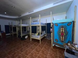 a room with three bunk beds in a room at Beach Dorms in San Juan