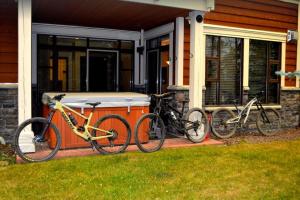 two bikes parked on the front of a house at Cozy 2 Bedroom 2 Bathroom Ski in Ski out Townhouse in Sun Peaks
