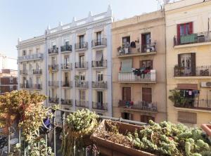 an apartment building with plants in front of it at Ndlr 2-4 · Authentic flat in Poble Sec - Paralelo in Barcelona