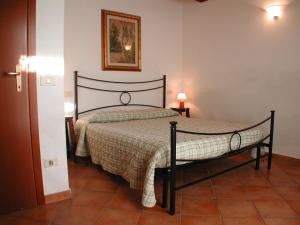 a bedroom with a bed with a checkered blanket at Appartamenti Il Granaio in Marina di Grosseto +59 photos