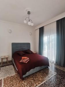 a bedroom with a bed and a large window at RODIES apartment in Chalkida