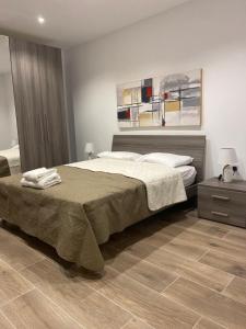 a bedroom with a large bed and a wooden floor at Sliema Living in Sliema
