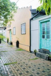 a house with a blue door and a brick street at Villa Harbour View in Galle