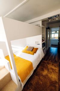 a bedroom with a large white bed with yellow blankets at Annexe with Sea View, Private Entrance & Parking - FOLKESTONE in Folkestone