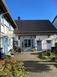 a white house with a patio in front of it at Haus-Hoeppches in Blankenheim
