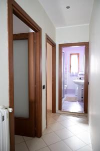 a hallway with two doors and a bathroom with a sink at La casa di Emma in Terni