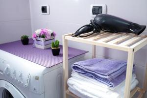a laundry room with a washing machine on a shelf at La casa di Emma in Terni