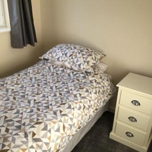 a small bedroom with a bed and a night stand at Bobs plac in Whitehaven