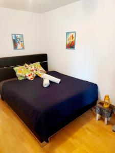 a bedroom with a large bed with a blue comforter at Large Apartment Bern City Centre in Bern