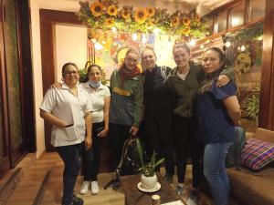 a group of women posing for a picture in a room at Posada J in Baños