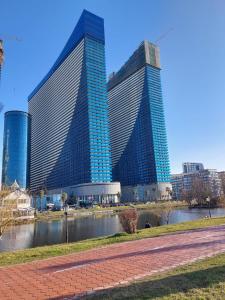 two tall buildings with a river in front of them at The best beach aparthotel Orbi city Batumi in Batumi