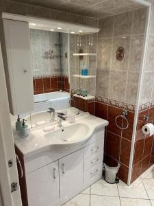 a bathroom with a white sink and a shower at Stunning views in Lochgoilhead