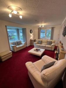 a living room with couches and a coffee table at Stunning views in Lochgoilhead